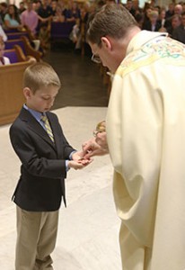 Little Boy Receiving First Holy Communion